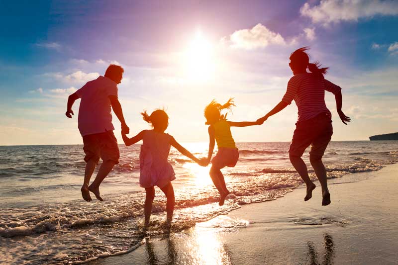 Family jumping on the beach surf - Accessing Wisdom